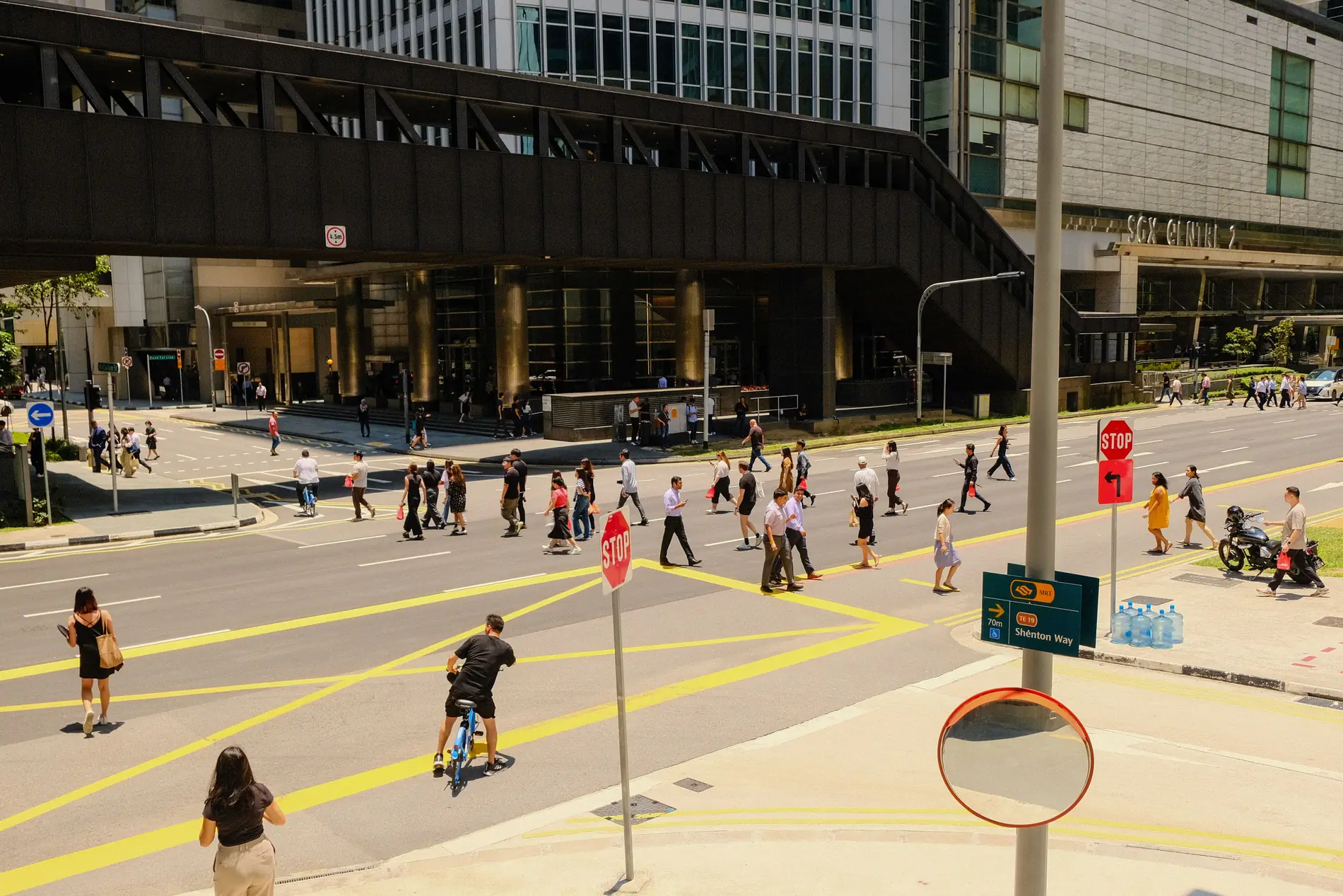 Pedestrians crossing a road in Singapore's central business district