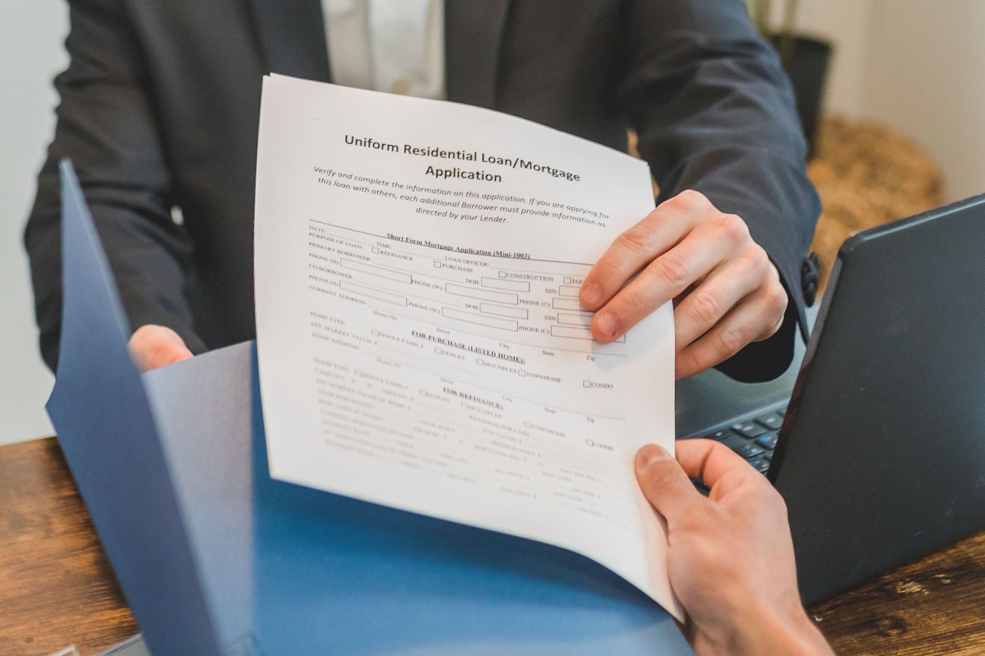 A homeowner reviewing a residential mortgage application with a loan officer
