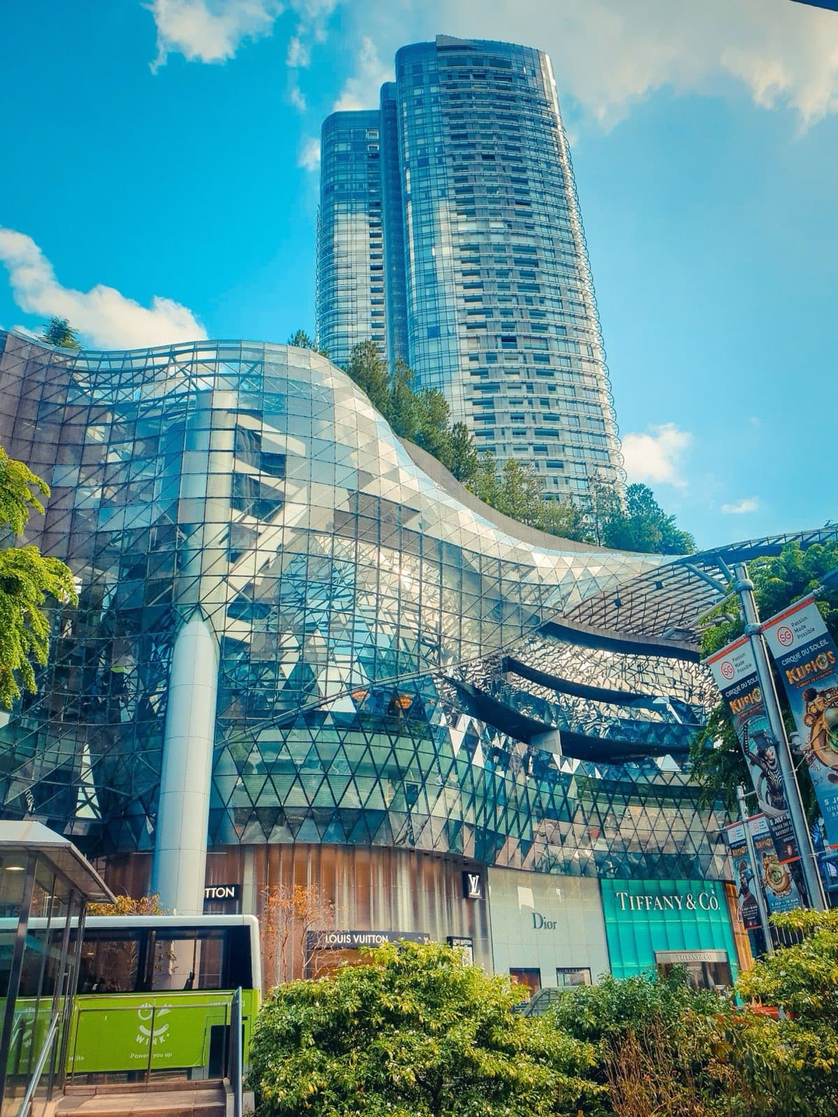 Modern condominium towers rising above an Orchard Road shopping mall